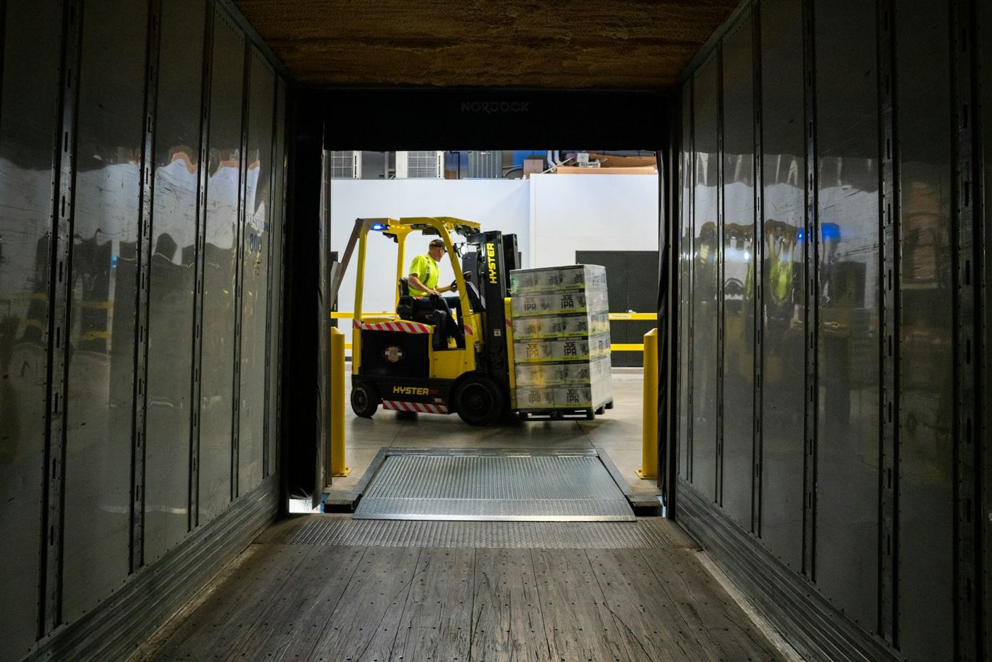Forklift loading pallets into a trailer