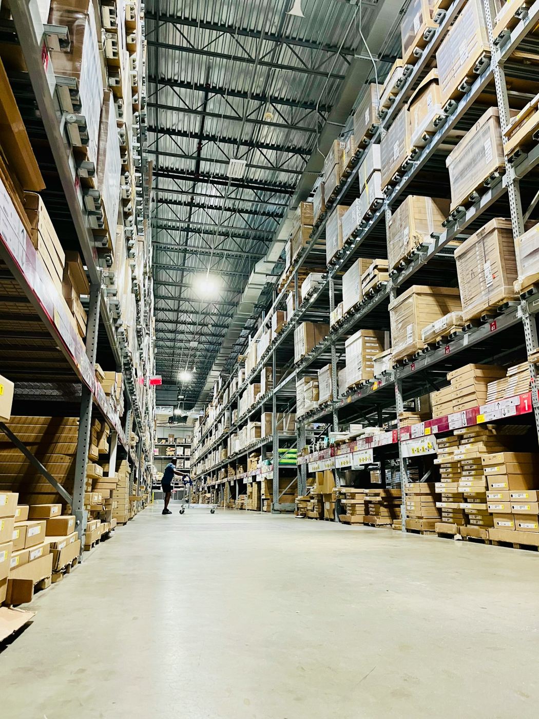 Warehouse aisle with shelves of boxed inventory
